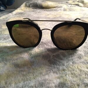 Prada Black Frame Sunglasses with Gold Lenses